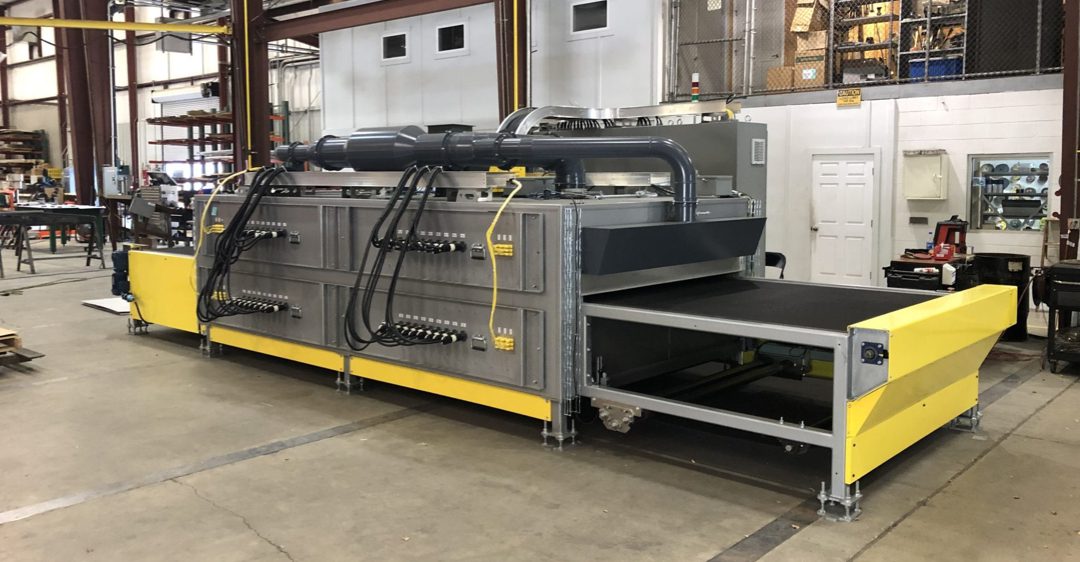 A custom-designed infrared industrial oven in a workshop.