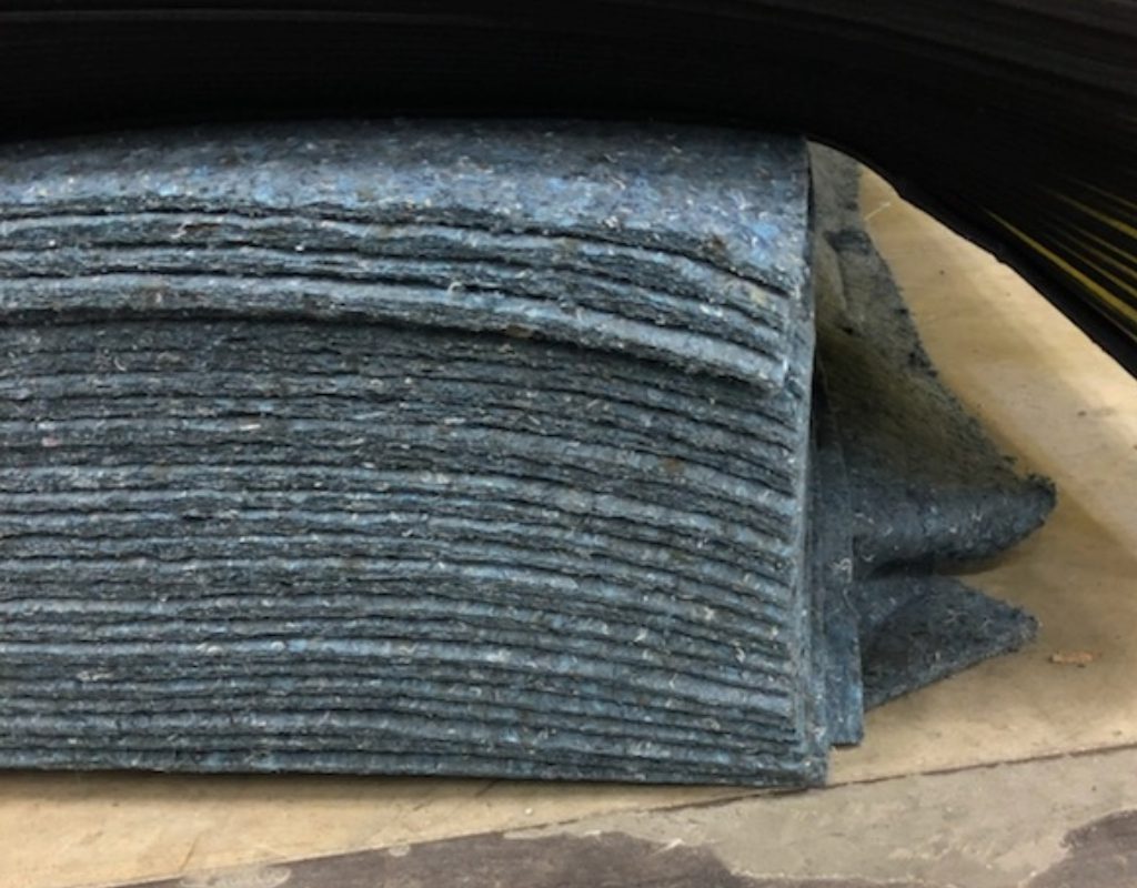 pile of automotive carpet insulation in factory